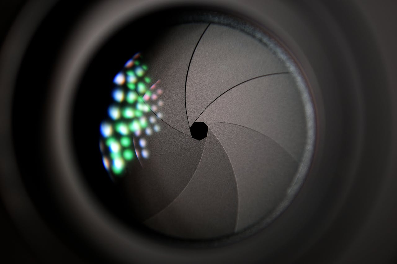 Services Detailed image of a camera lens aperture showing mechanical blades.